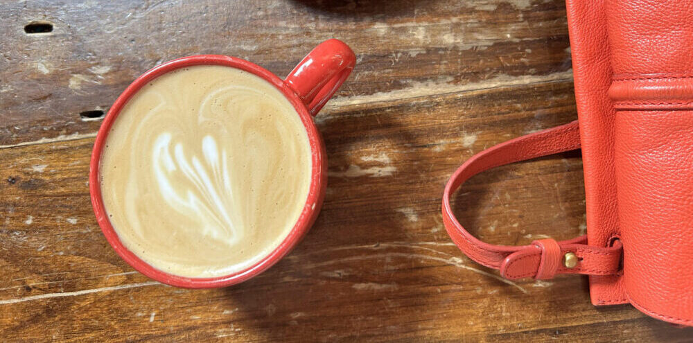Red coffee cup for a guest on the wooden table